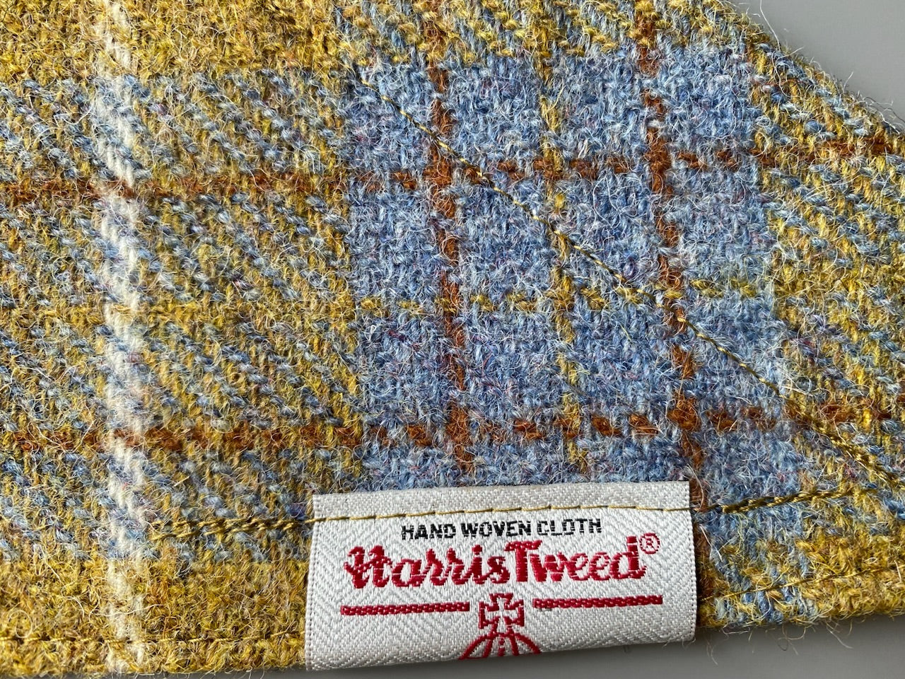 Harris Tweed dog bandana neckerchief in Mustard yellow / gold & blue check tartan or plaid pattern. Sizes S, M, L + XL pet scarf