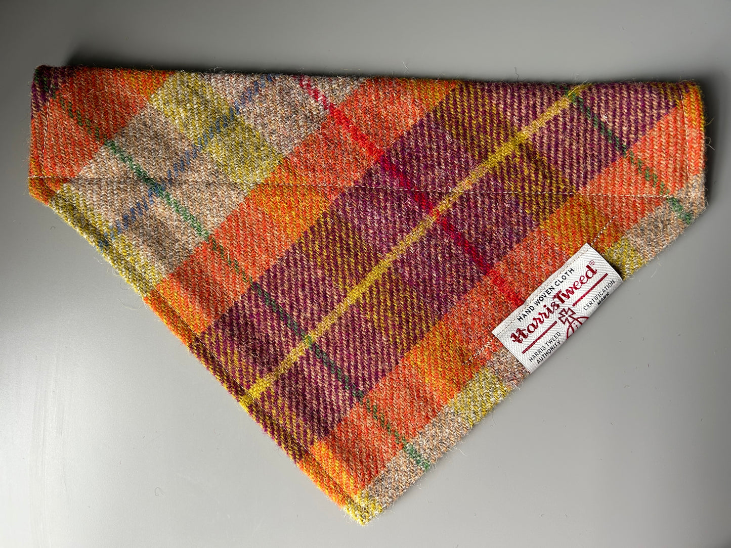 Harris Tweed dog bandana neckerchief in orange beige and purple in a check, tartan pattern. Sizes S M L XL pet scarf