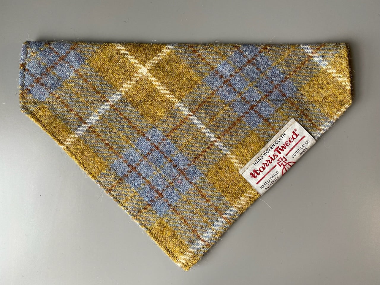 Harris Tweed dog bandana neckerchief in Mustard yellow / gold & blue check tartan or plaid pattern. Sizes S, M, L + XL pet scarf